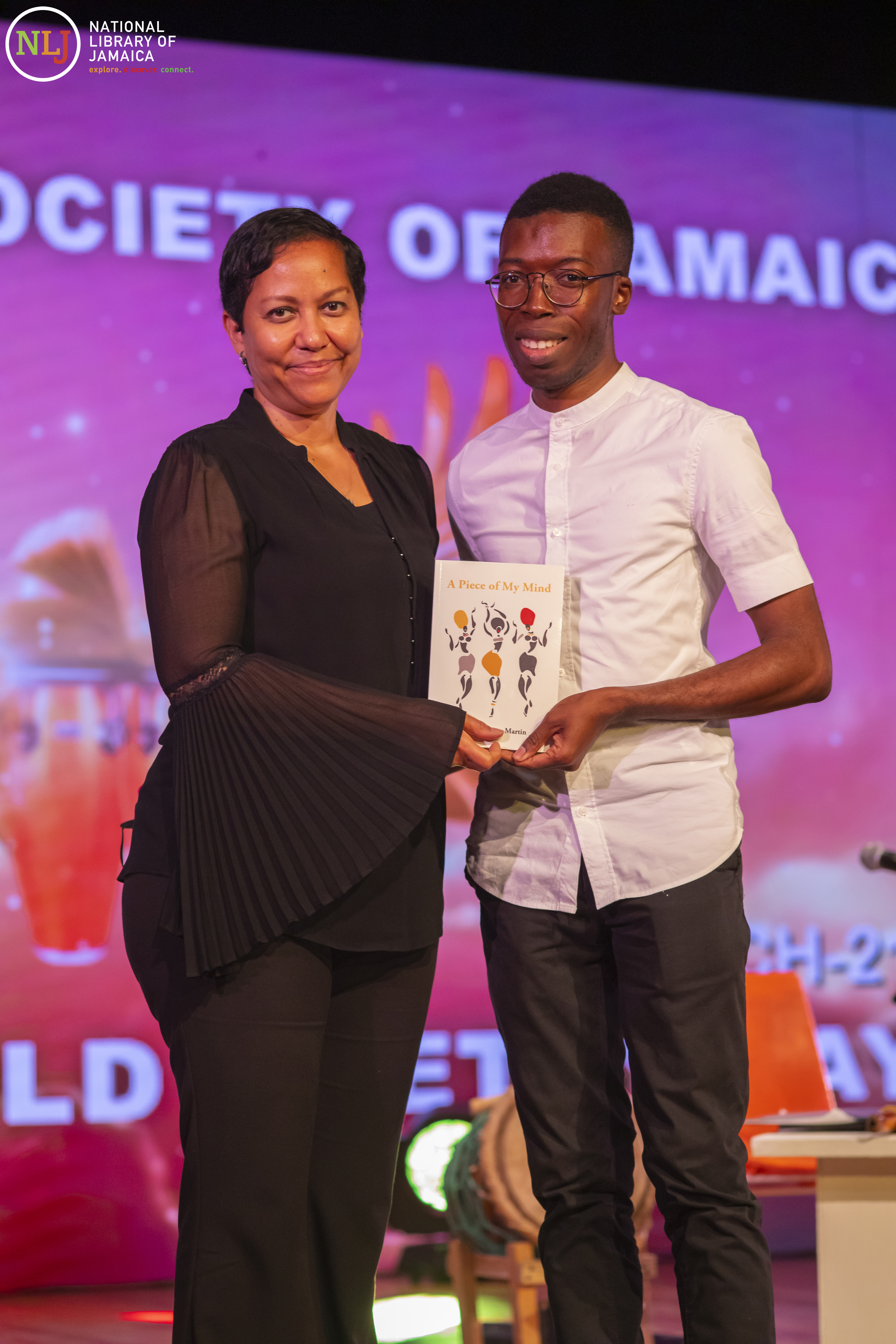 OAS Rep presents book to poet at World Poetry Day during IAWAD